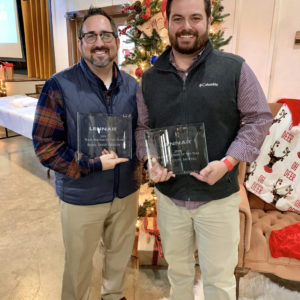 Little Guys Movers Austin manager holding Lennar award with Brian David Design