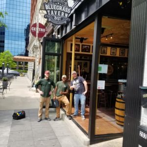 Three Little Guys standing outside Bluegrass Tavern in Lexington