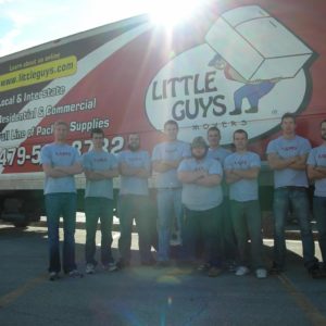 Original Fayetteville Little Guys Movers standing in front of moving truck