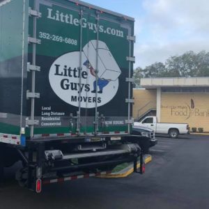 Little Guys Movers truck in front of Bread of the Mighty building