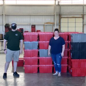 Little Guys Movers employee with Food2Kids staff member and food boxes