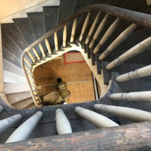 Staircase viewed from above with Little Guy employee at the bottom