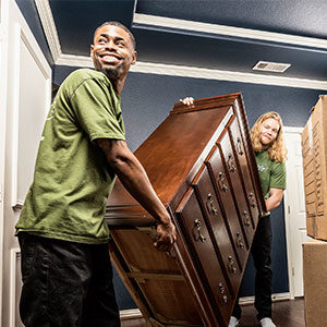 Two Little Guys antique movers moving a dresser