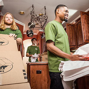 Little Guys Movers employees with boxes completing a full-service move