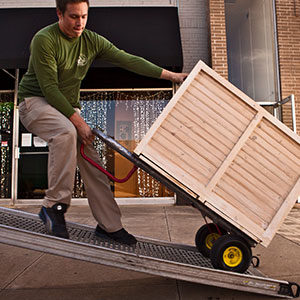 Little Guys employee putting box on truck during office move