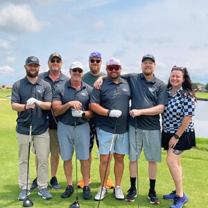 A group from Little Guys Movers host the Heckle Hole at McKinney's Chamber Golf Tournament