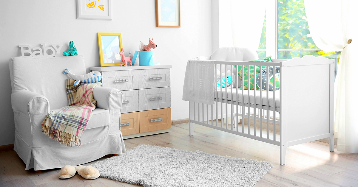 Bright and sunny baby's room with crib, dresser, and colorful pictures on the walls