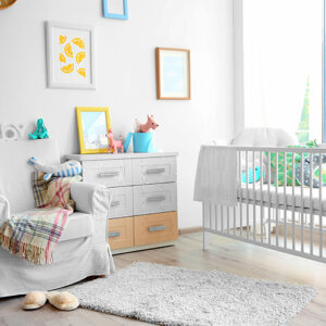 Bright and sunny baby's room with crib, dresser, and colorful pictures on the walls