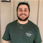 Mover Jacob in a hat and green Little Guys Movers t-shirt