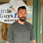 Mover Samuel in front of the Little Guys Movers office in San Antonio