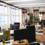 Interior of an open-air office with desks and computers.